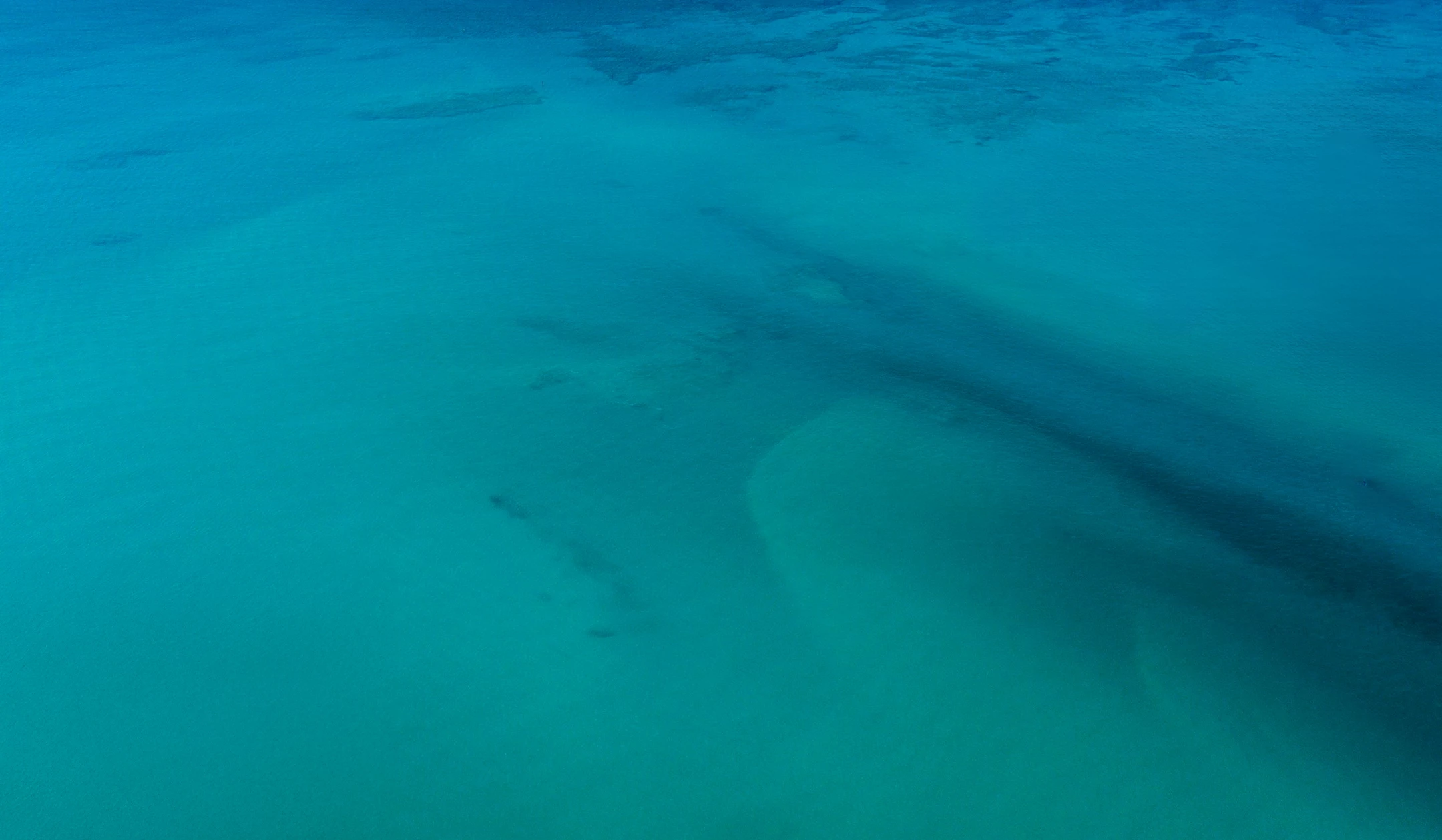 a blue water with a large body of water