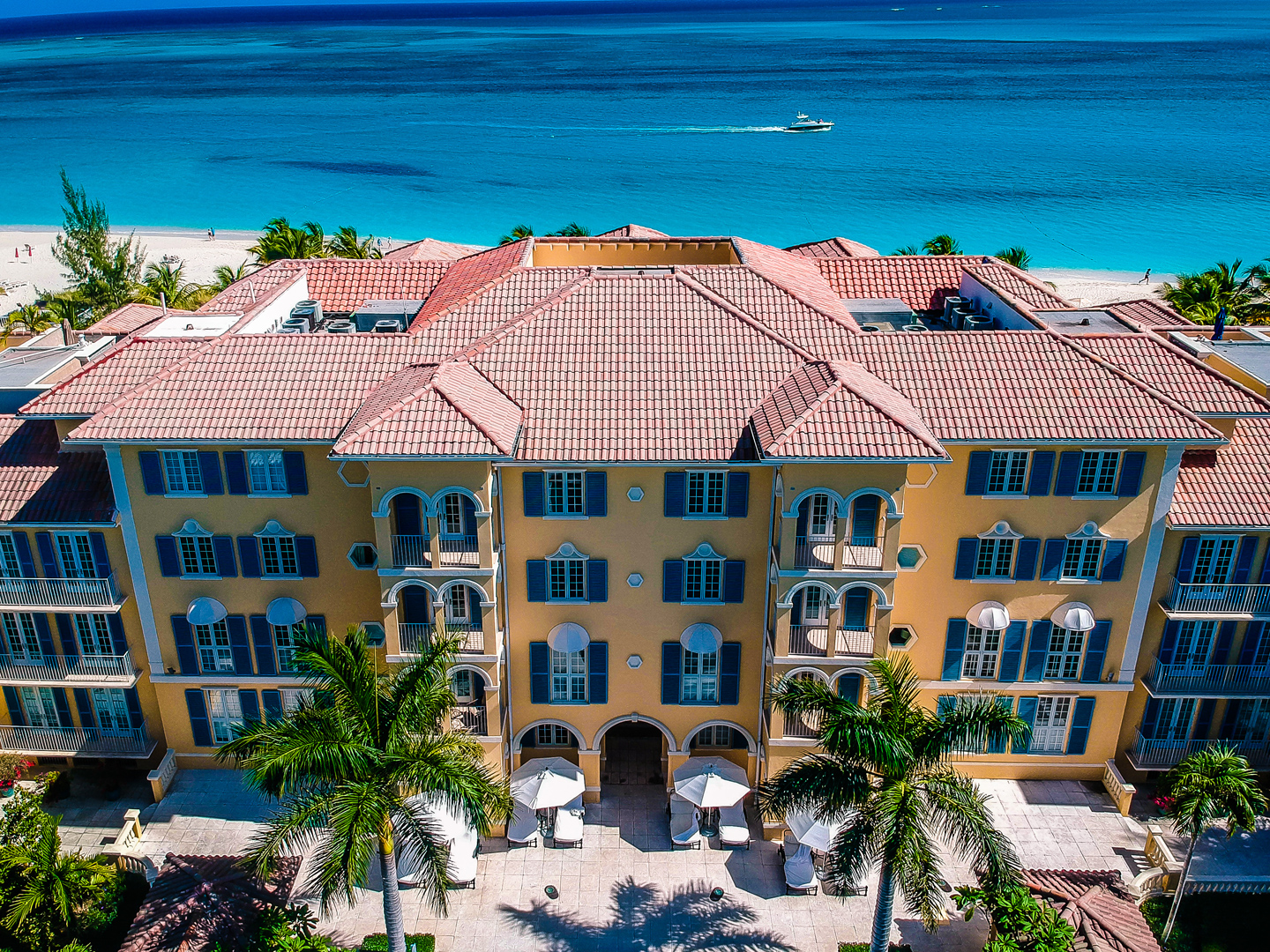 a building with palm trees and a beach