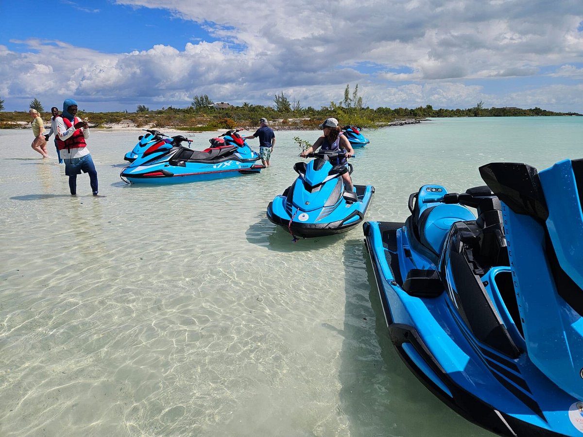 people on jet skis in shallow water
