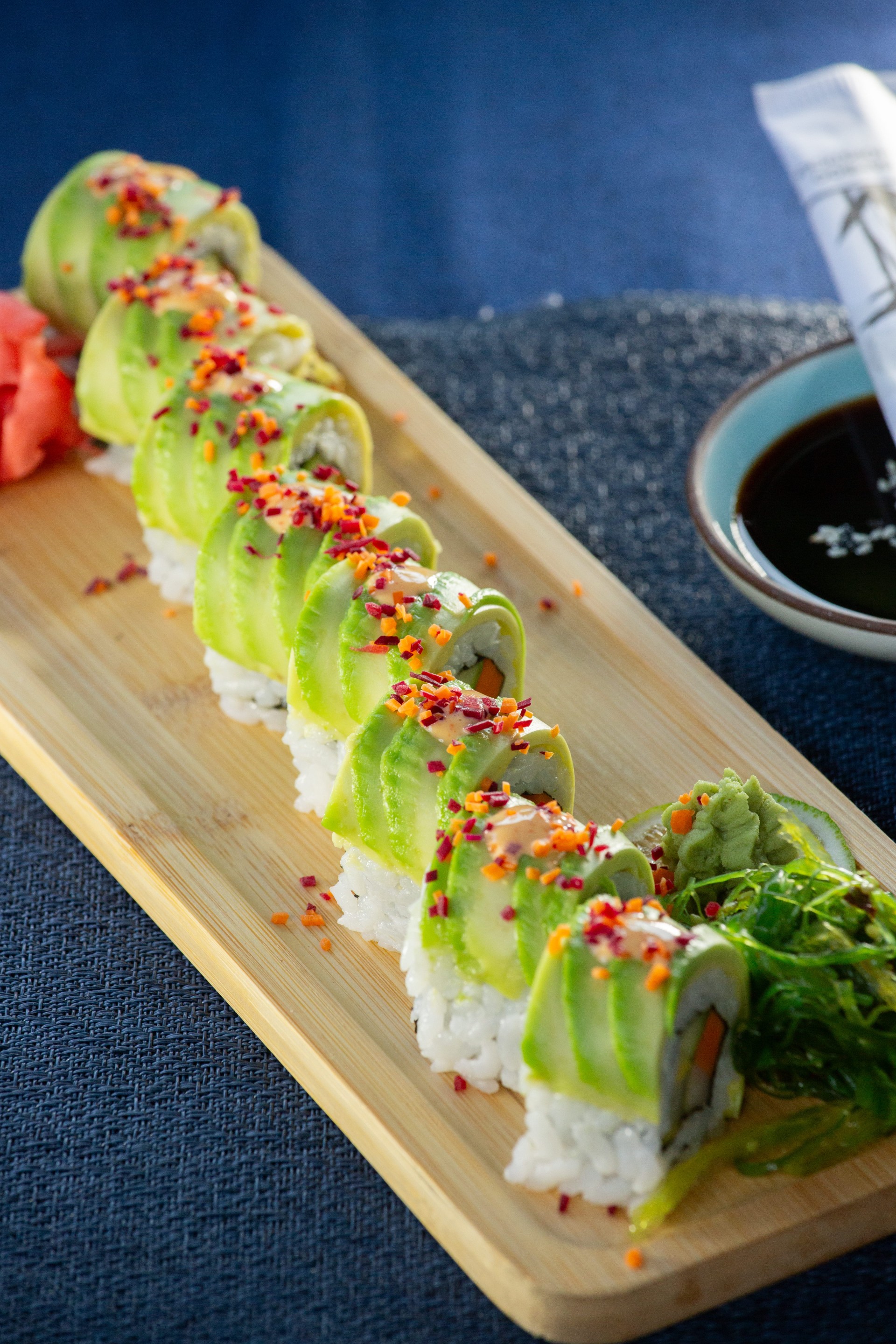 a plate of sushi on a blue surface