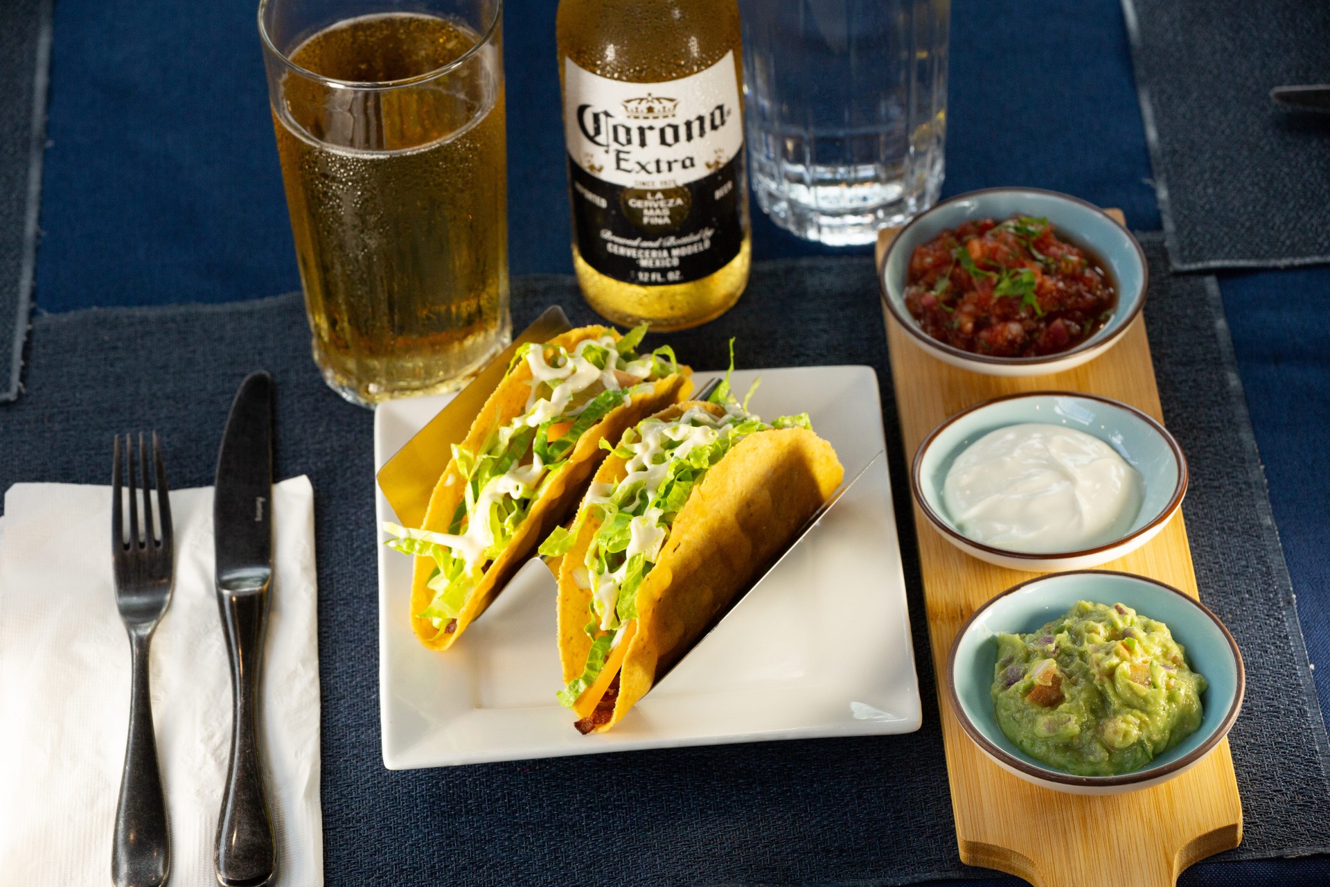 a plate of tacos and drinks