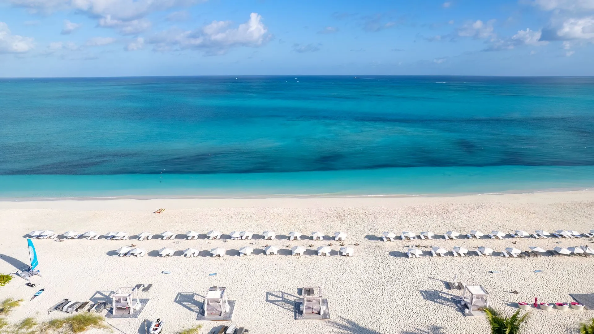 a beach with chairs and umbrellas
