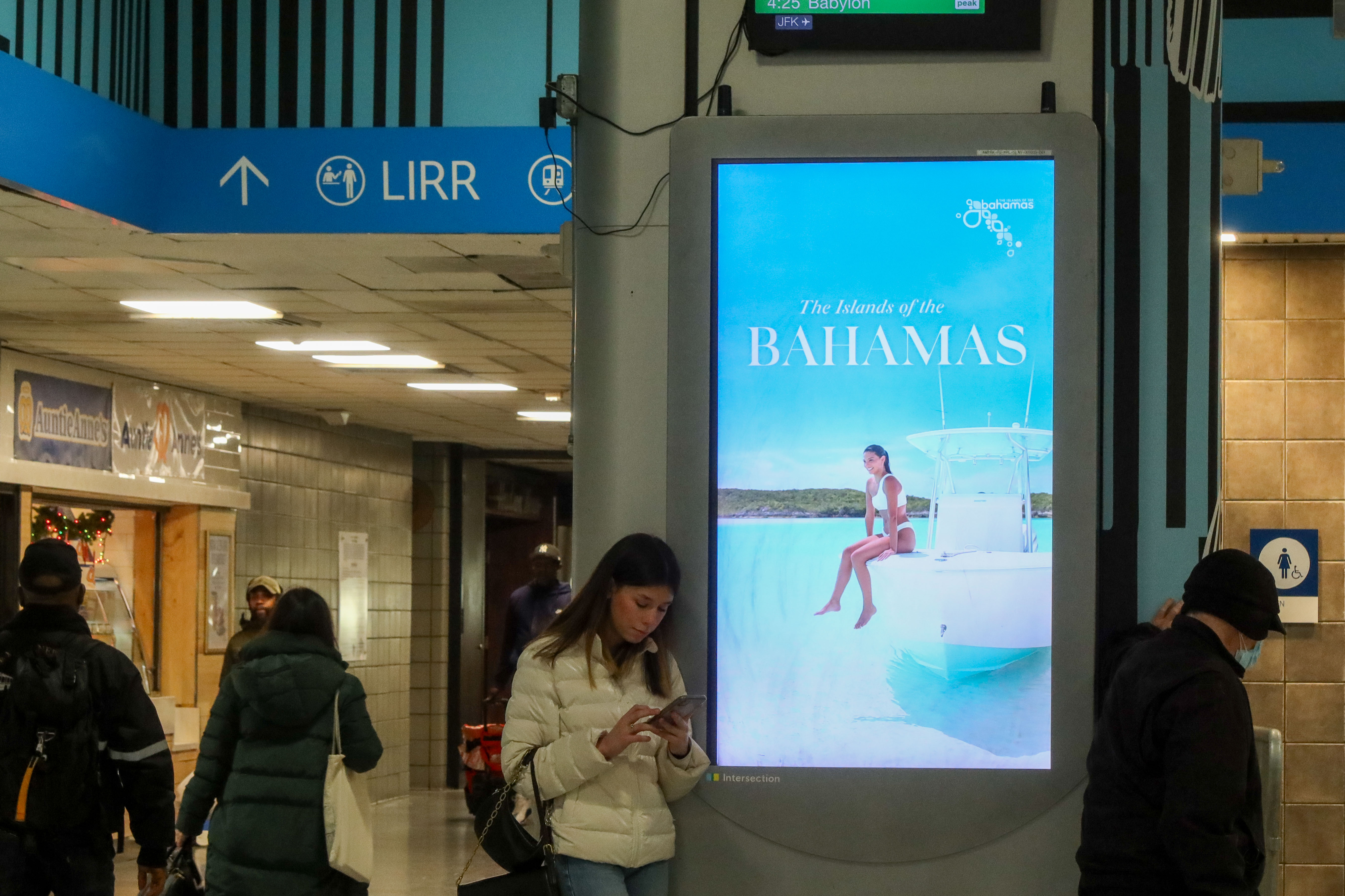 a person standing in front of a large screen