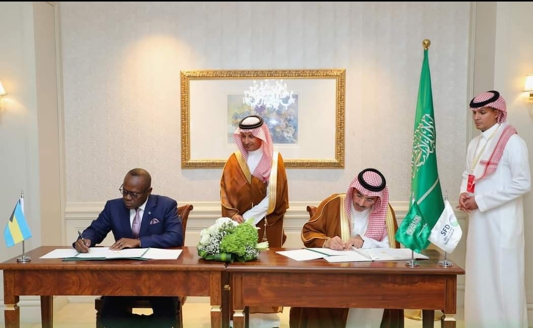 a group of people sitting at a table with flags