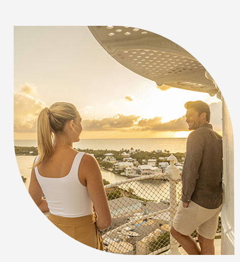 a man and woman looking at a beach