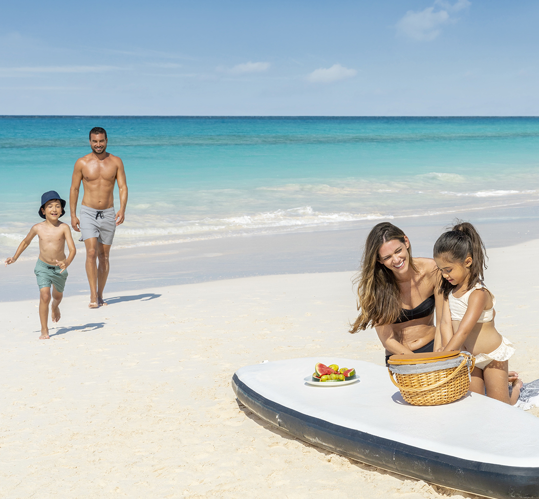 a woman and two children on a beach