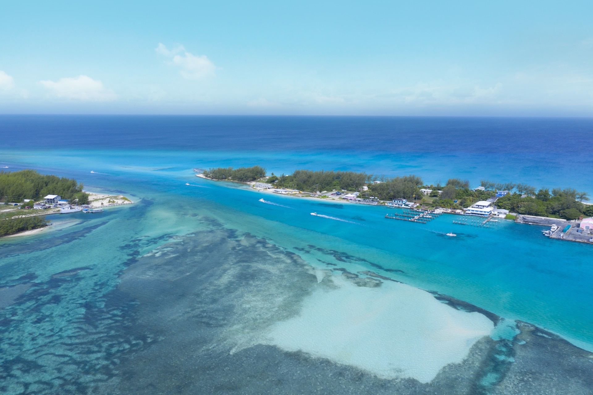 a blue water with a small island and boats