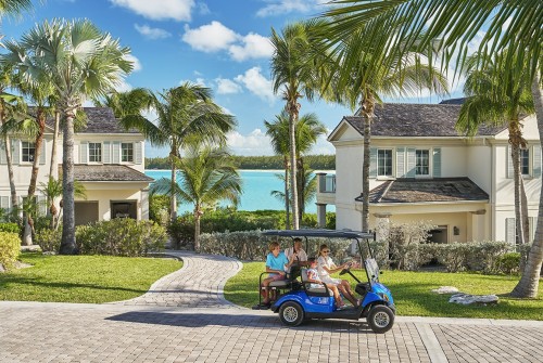 a group of people in a golf cart