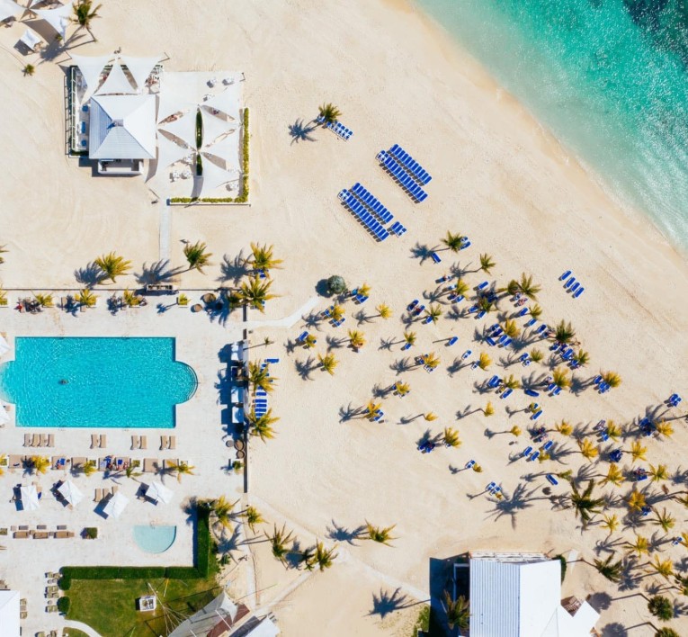 a beach with a swimming pool and a building