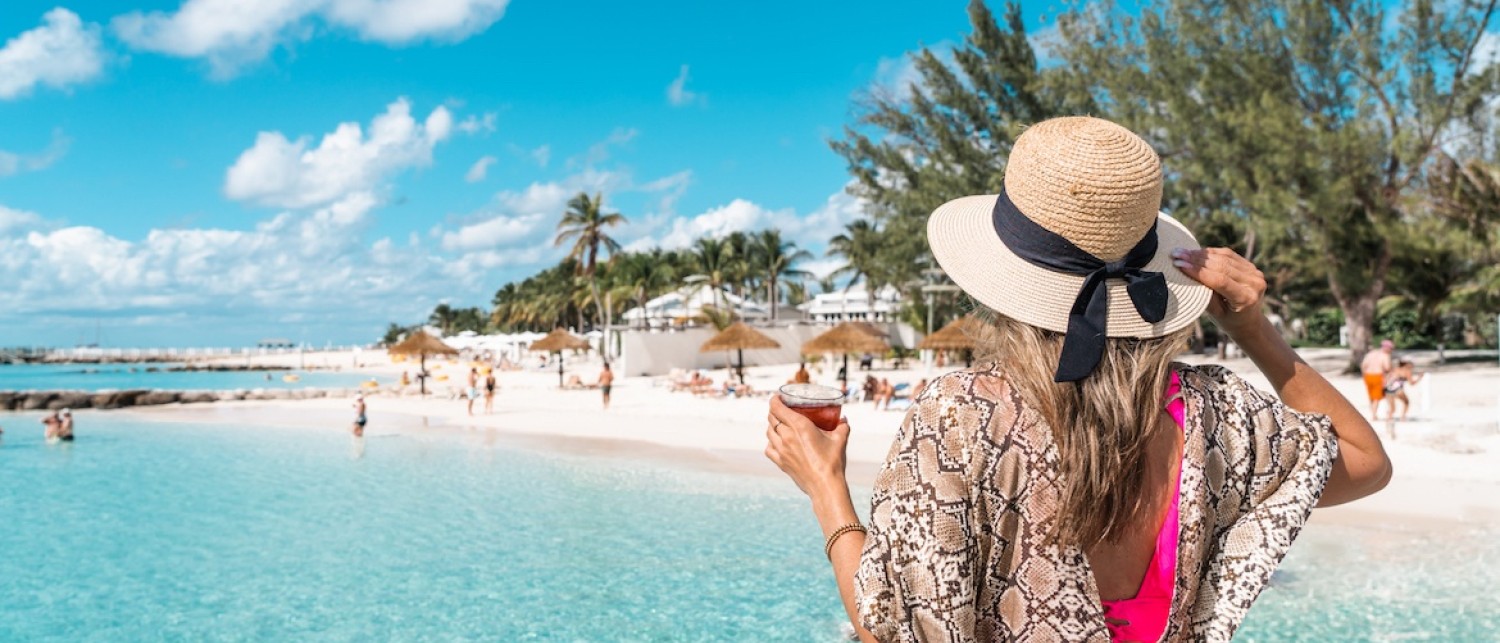 a woman in a hat on a beach