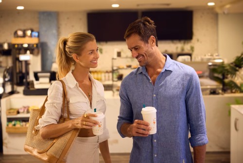 a man and woman holding coffee cups