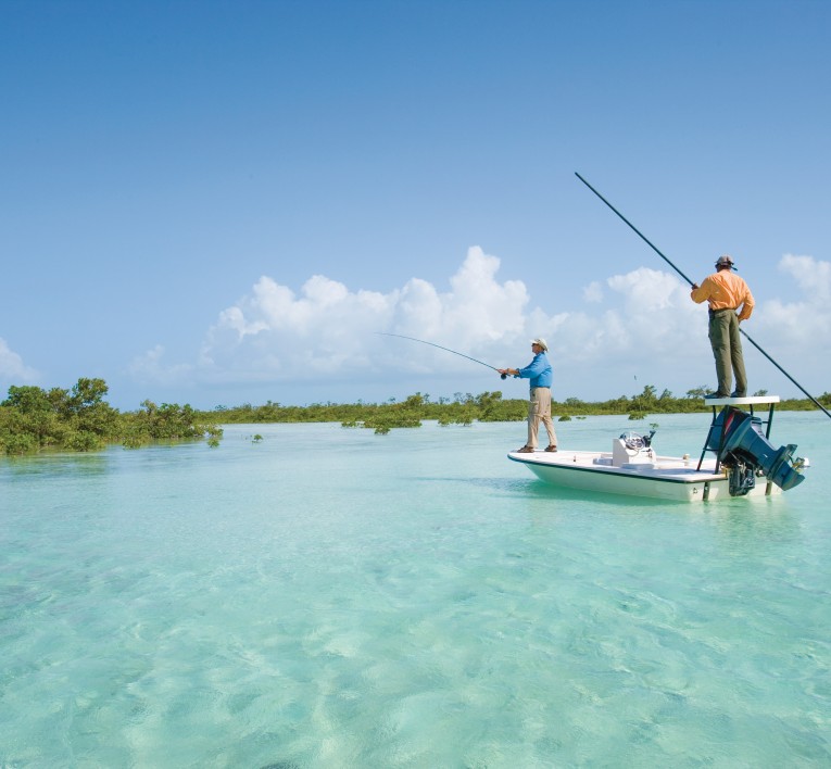 a group of men fishing on a boat in the water