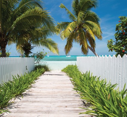 a wooden walkway leading to a beach
