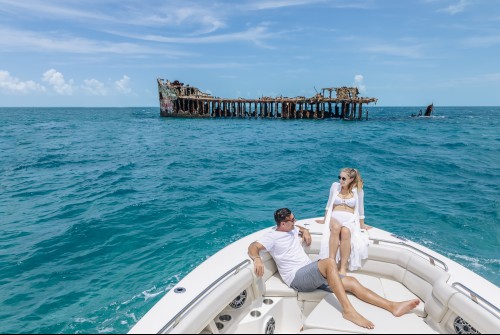 a man and woman on a boat in the water