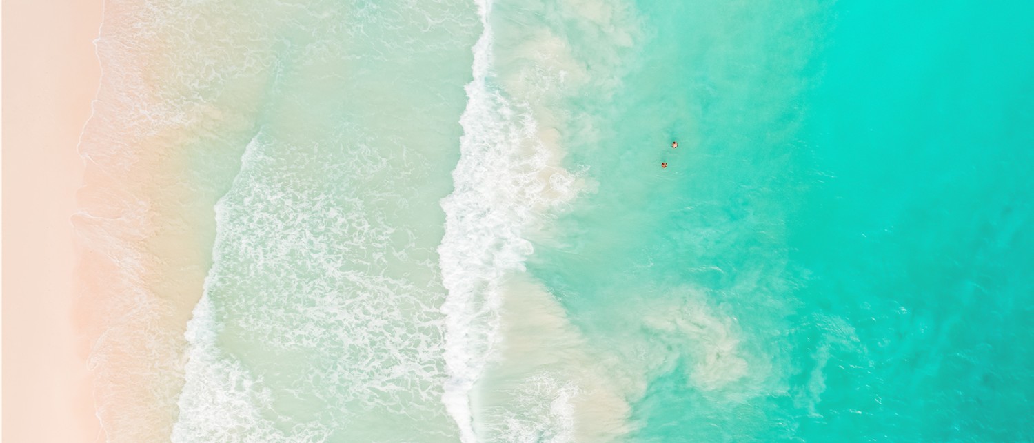 a couple of people swimming in the ocean