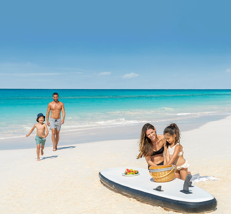 a woman and two children on a beach