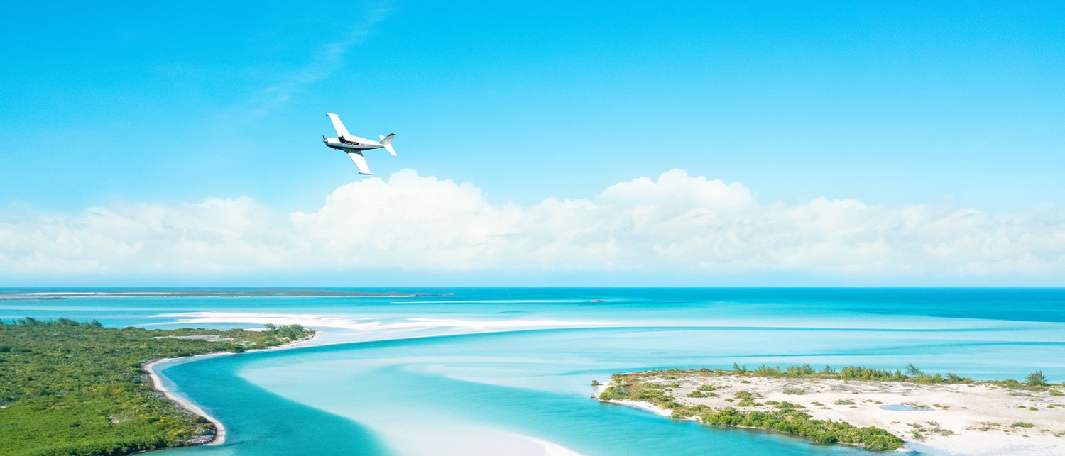 an aerial of a plane flying over water