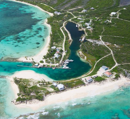 a aerial view of a beach with a dock and boats