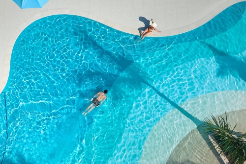 a man and woman swimming in a pool