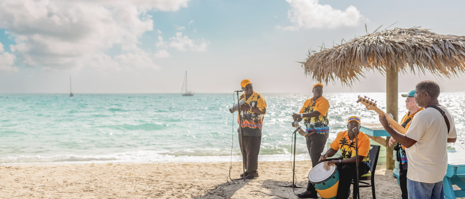 a group of people playing instruments on a beach
