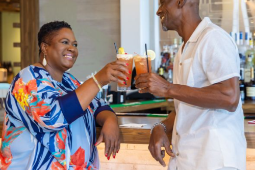 a man and woman holding drinks