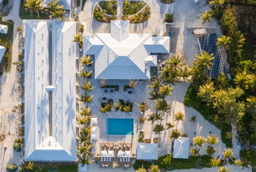 a building with a pool and trees around it