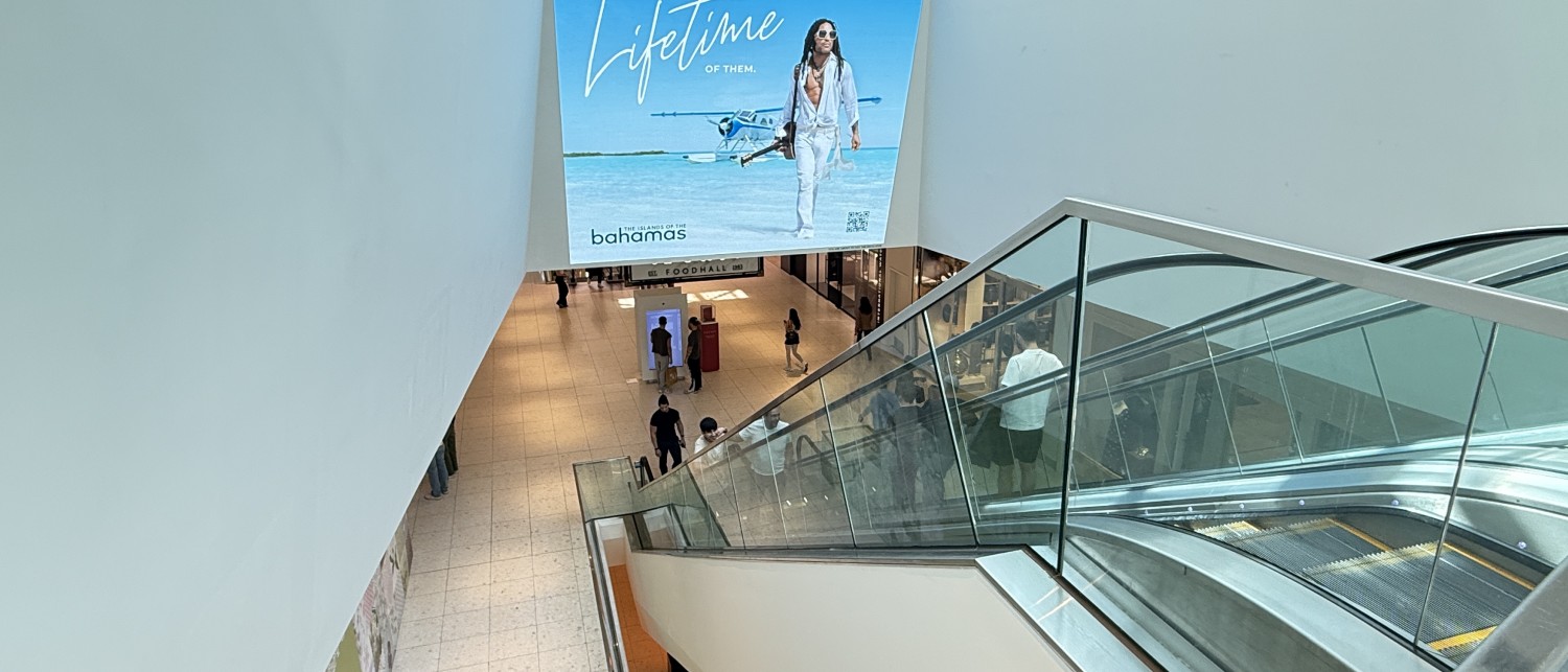 a large screen on a wall above a staircase