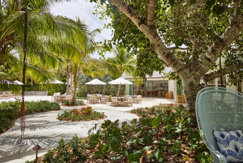 a patio area with chairs and umbrellas