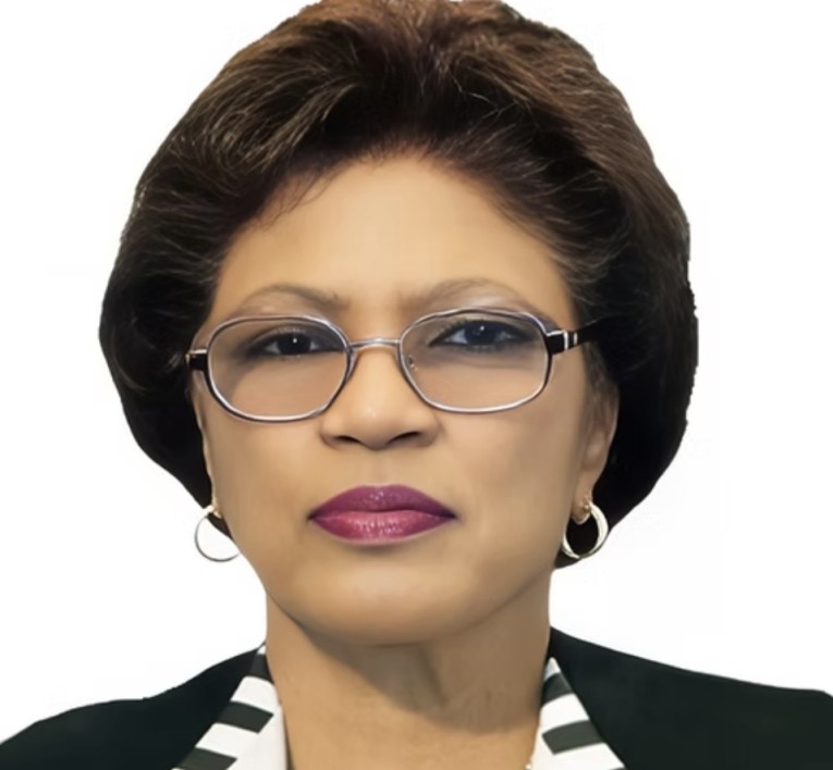 a woman wearing glasses and a black and white striped jacket