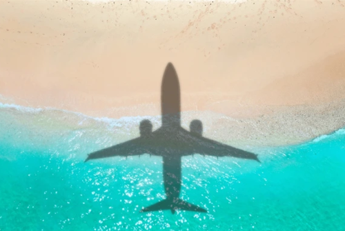 an airplane shadow over water