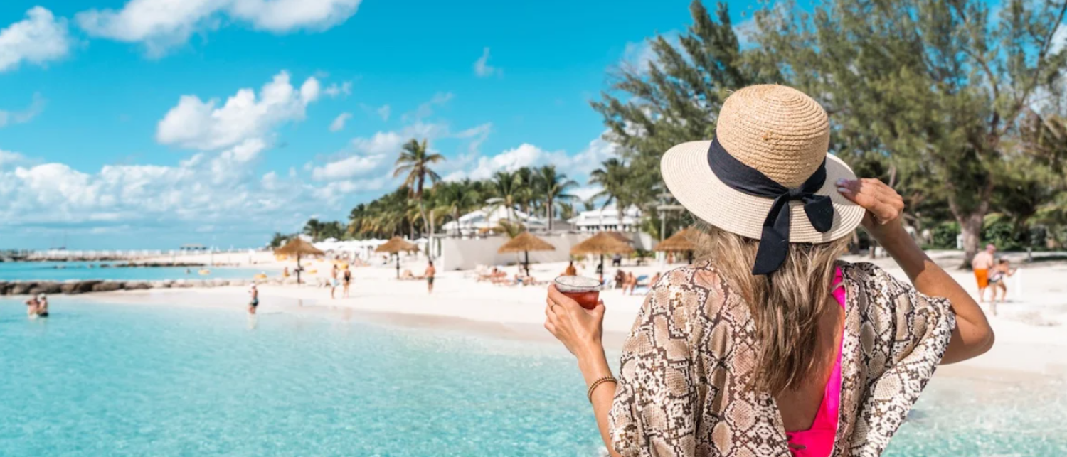 a woman in a hat on a beach
