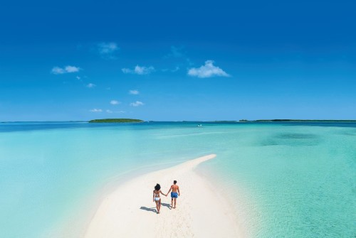 a couple walking on a beach