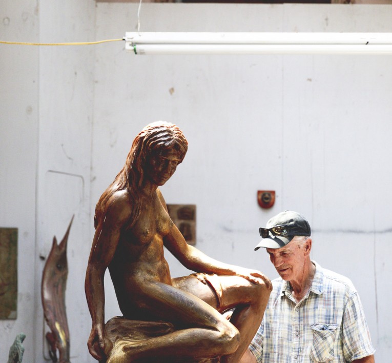 a man looking at a statue