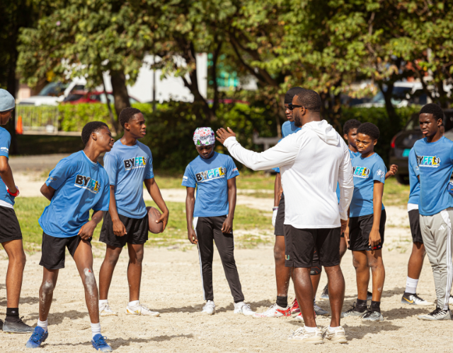 a group of people standing in a circle with a man standing next to each other
