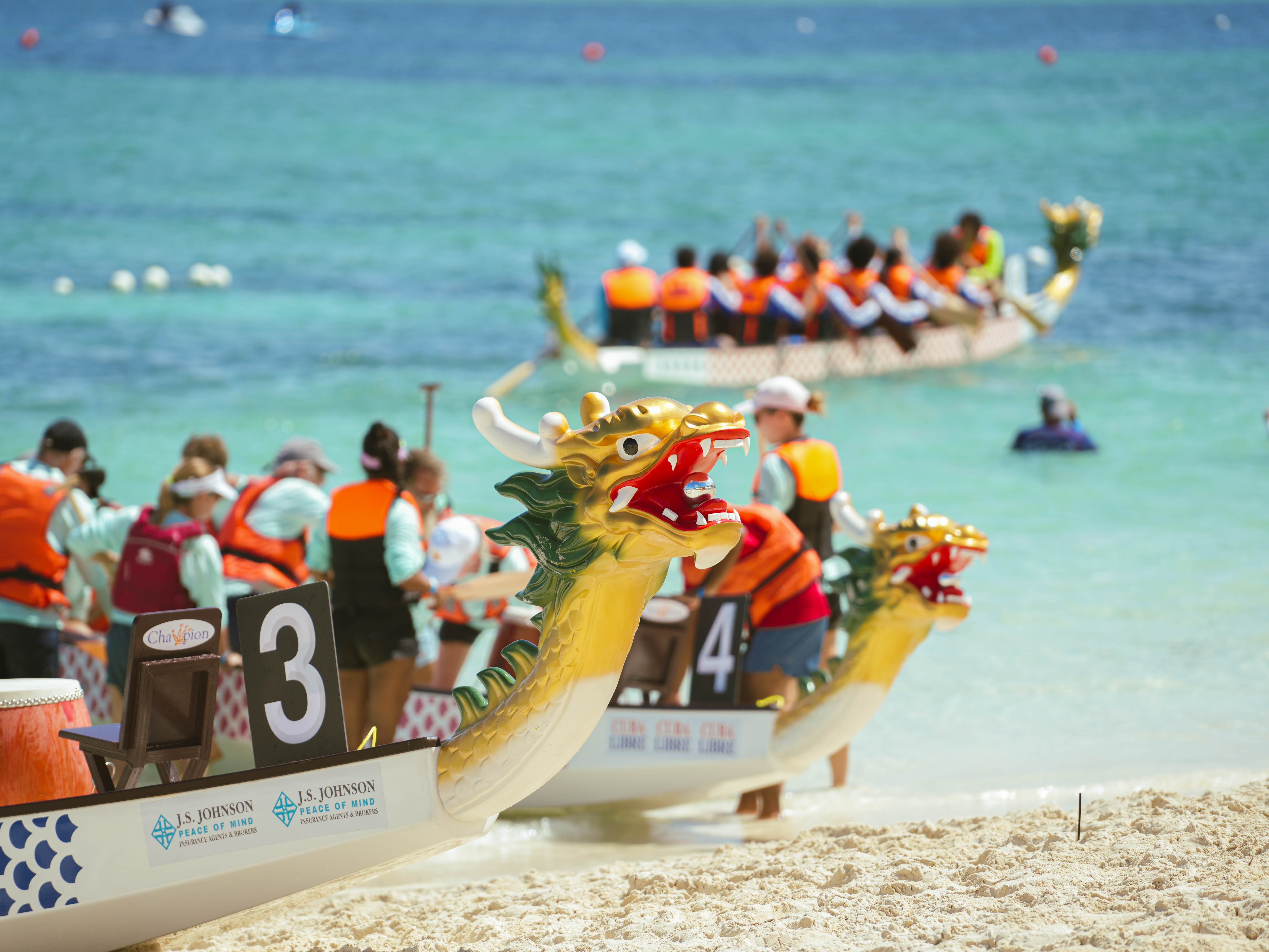 a group of people on a beach with boats