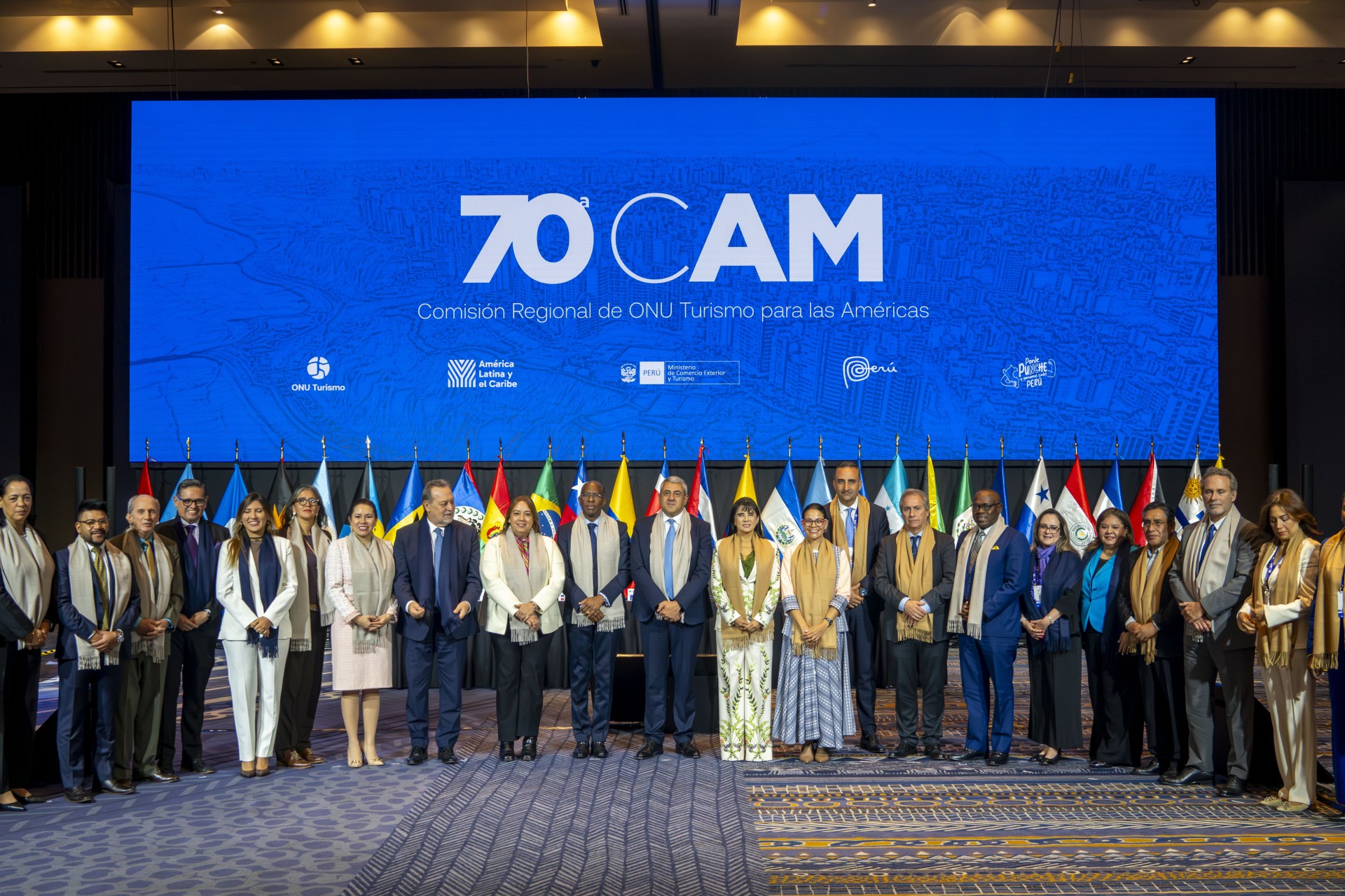 a group of people standing in front of a large screen