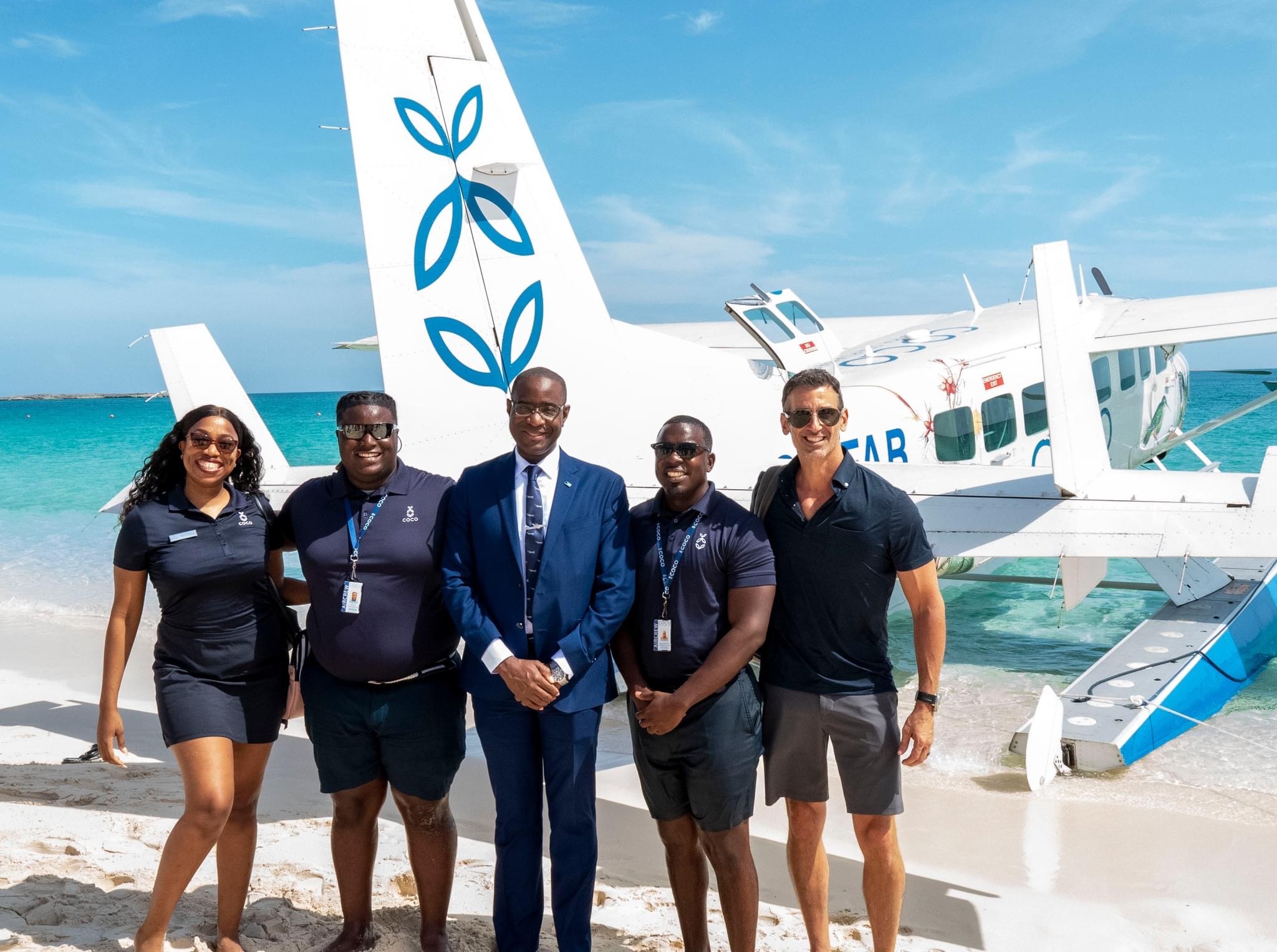 a group of people posing for a photo in front of an airplane