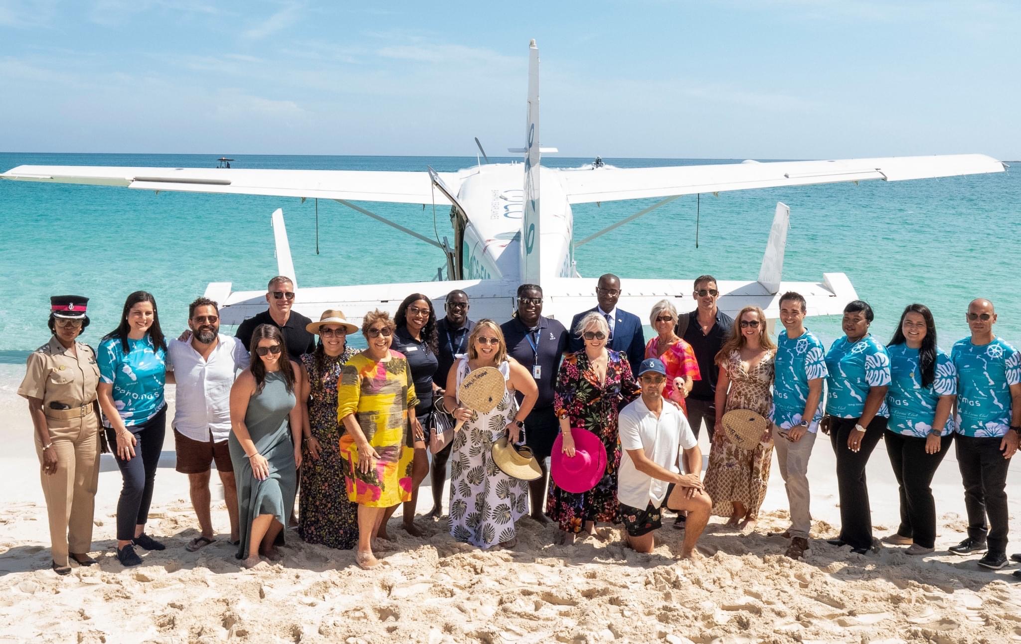 a group of people posing for a photo on a beach
