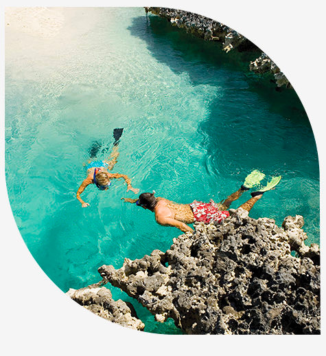 Couple snorkeling and aerial view of an island
