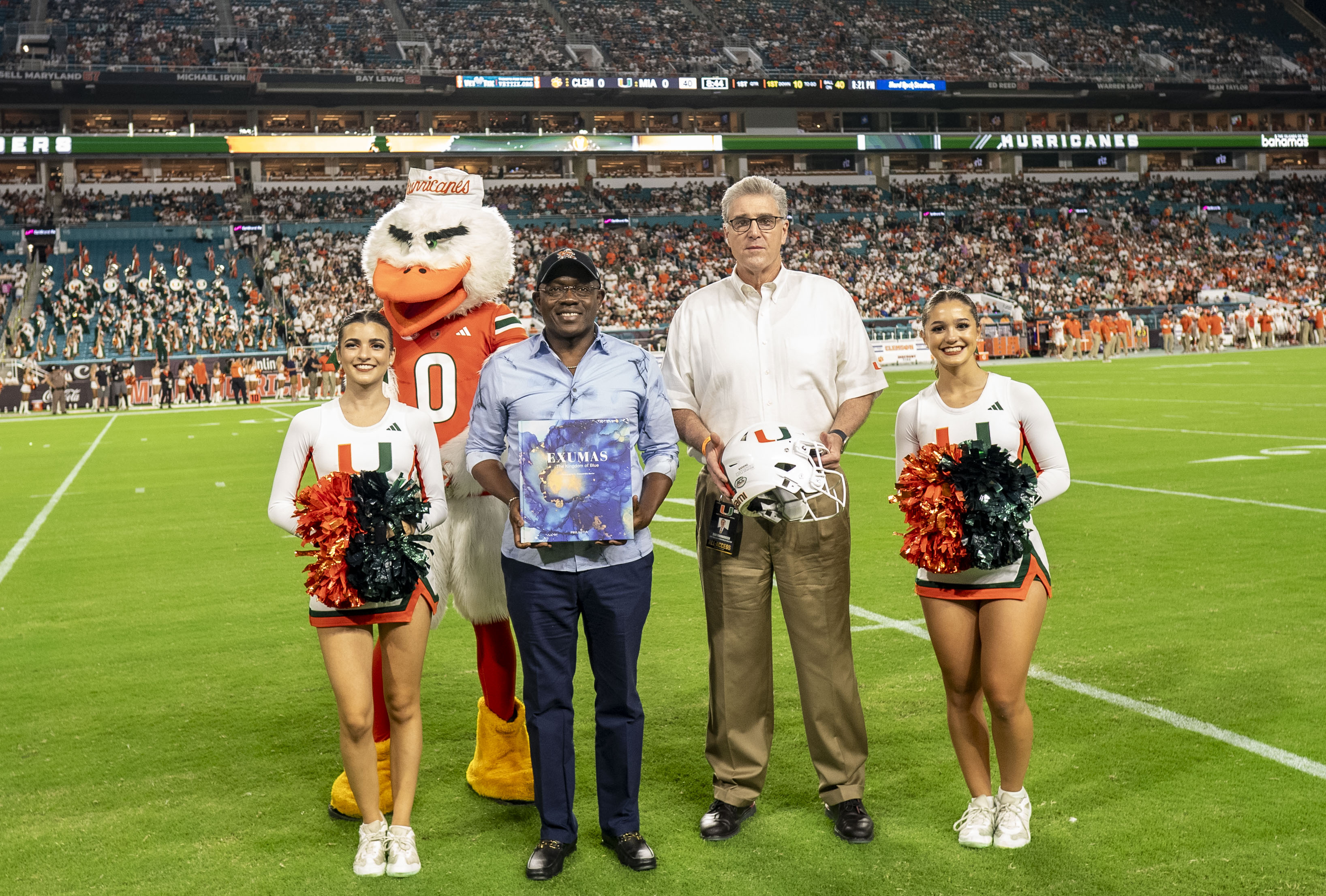 a group of people posing for a photo with a mascot
