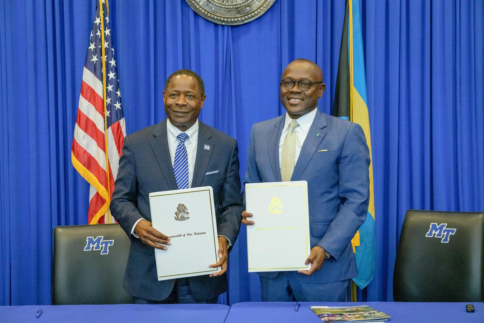 two men in suits holding certificates