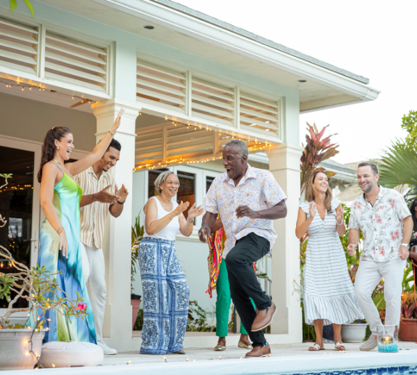 a group of people dancing outside a house